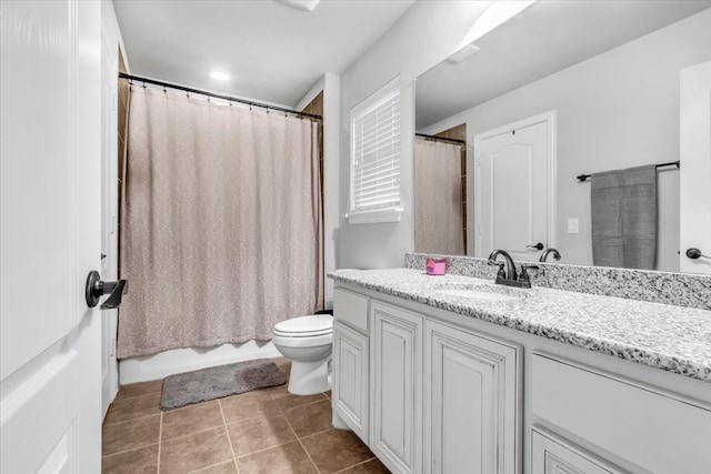 full bathroom featuring shower / bath combo with shower curtain, tile patterned flooring, vanity, and toilet