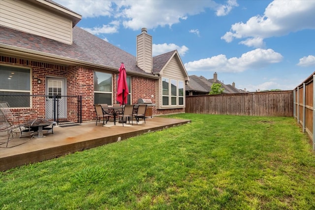 view of yard with a fire pit and a patio