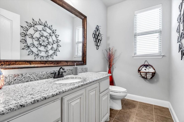 bathroom featuring tile patterned floors, vanity, and toilet