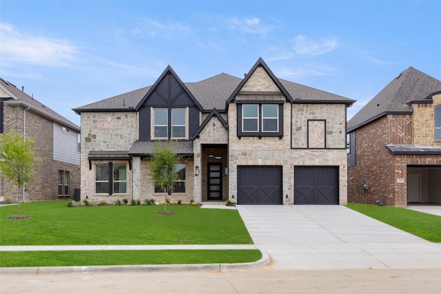 view of front of home with a garage, cooling unit, and a front lawn