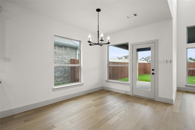 unfurnished dining area with a wealth of natural light and light hardwood / wood-style flooring