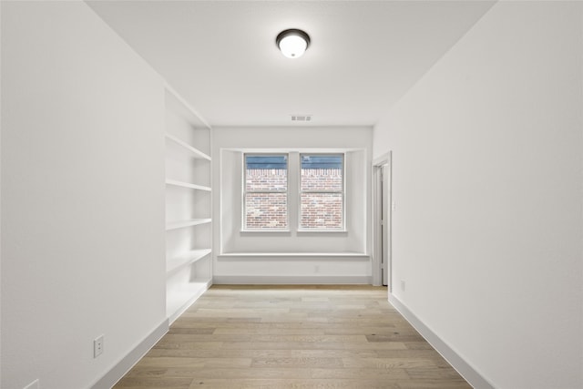 hall with light hardwood / wood-style flooring