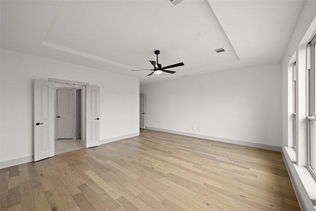 unfurnished room featuring ceiling fan, plenty of natural light, and light wood-type flooring