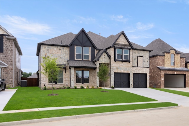 view of front of house with a garage, central AC unit, and a front yard