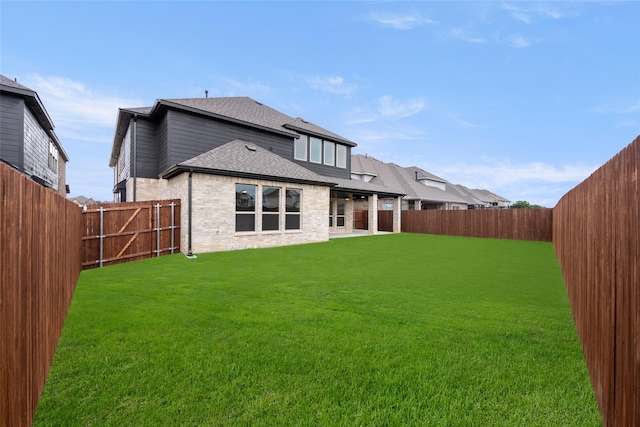 back of house featuring a yard