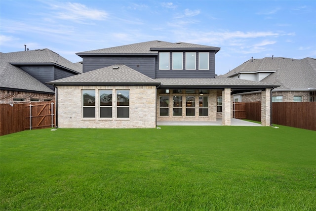 back of property with a patio and a yard