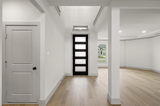 foyer entrance with light hardwood / wood-style floors