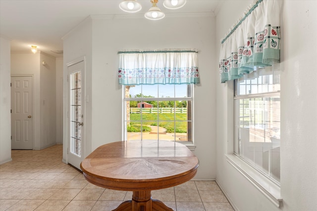 interior space featuring crown molding and light tile floors