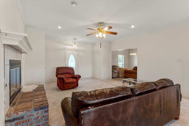 carpeted living room with ornamental molding and ceiling fan