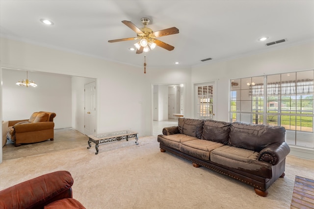 carpeted living room with crown molding and ceiling fan with notable chandelier