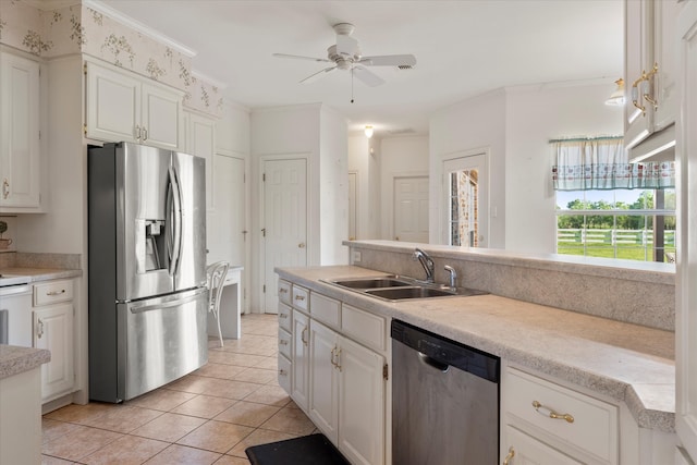 kitchen with white cabinets, appliances with stainless steel finishes, ceiling fan, and light tile floors