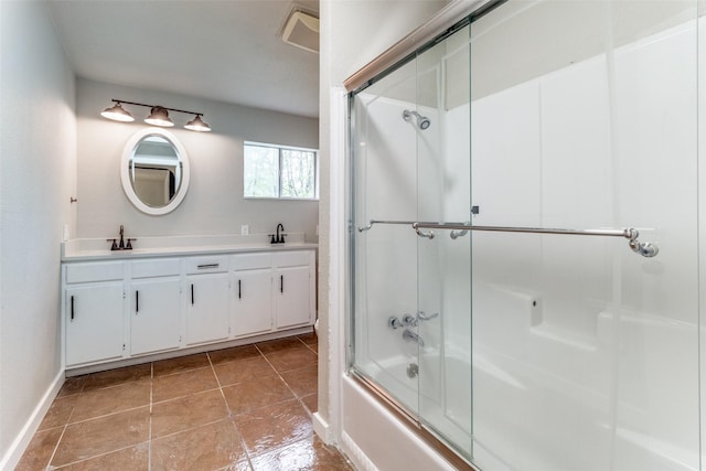 bathroom featuring vanity and shower / bath combination with glass door