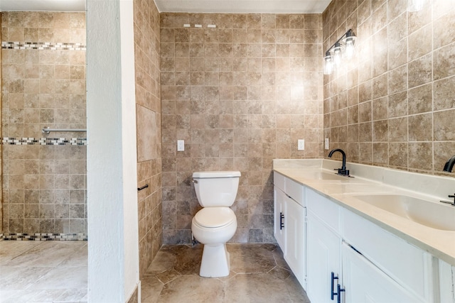 bathroom featuring vanity, tile walls, and toilet