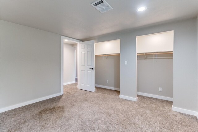 unfurnished bedroom featuring light colored carpet