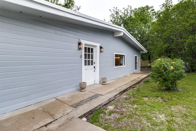 view of exterior entry featuring a patio area