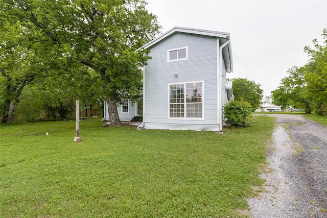 back of property featuring a yard