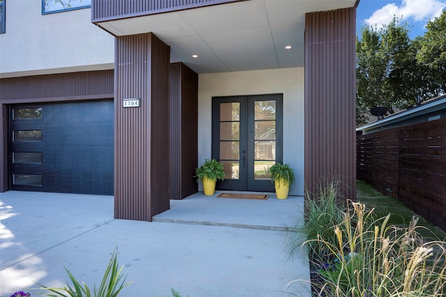 entrance to property featuring french doors and a garage