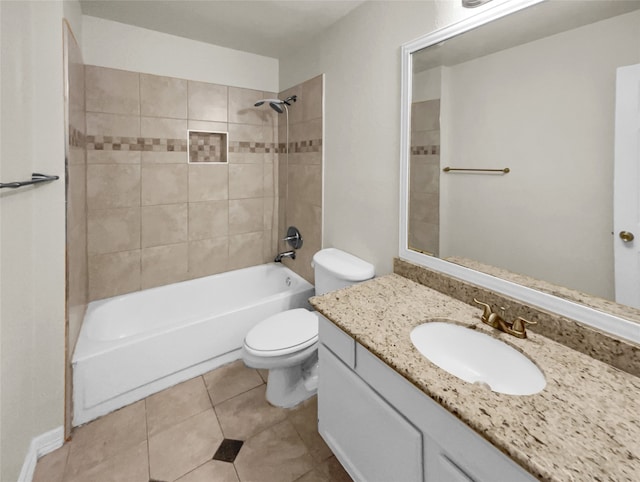 full bathroom with tile patterned floors, tiled shower / bath, vanity, and toilet