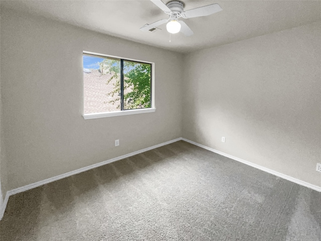 carpeted spare room featuring ceiling fan