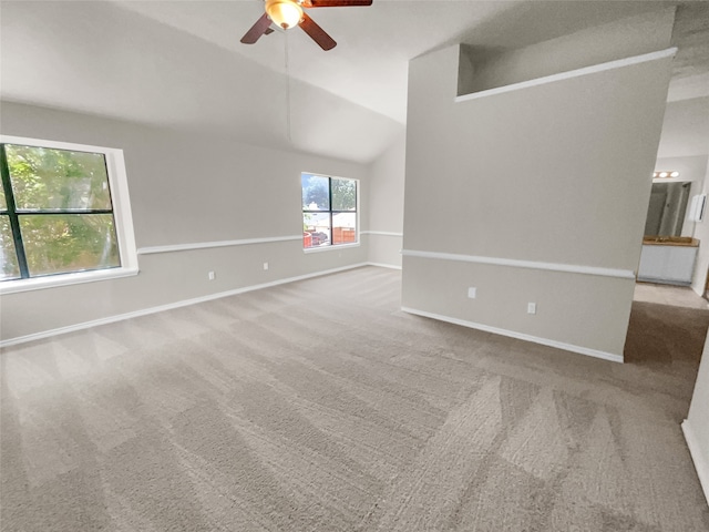 carpeted empty room with ceiling fan and lofted ceiling