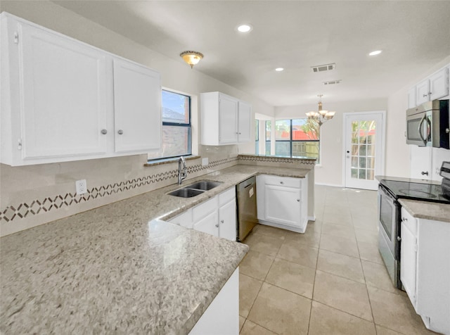 kitchen with sink, white cabinets, kitchen peninsula, an inviting chandelier, and appliances with stainless steel finishes