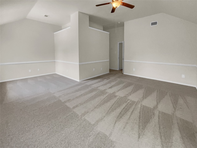 unfurnished room featuring lofted ceiling, ceiling fan, and carpet floors