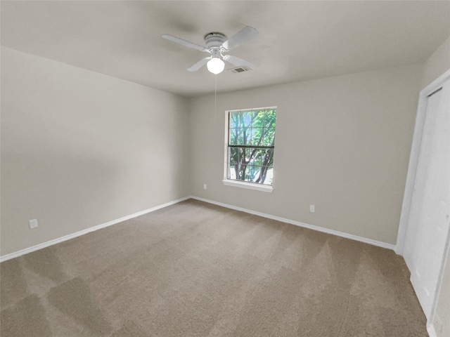 carpeted empty room with ceiling fan