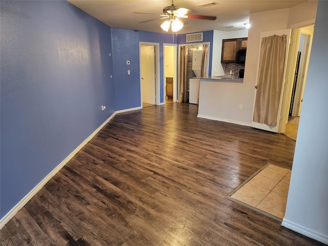 spare room featuring dark wood-type flooring and ceiling fan