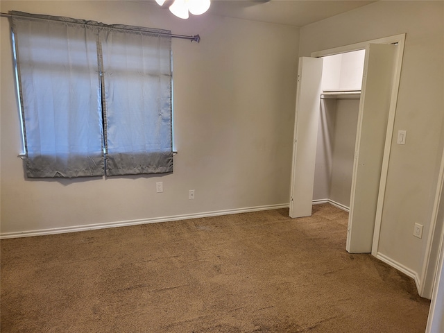 unfurnished bedroom featuring a closet and carpet flooring