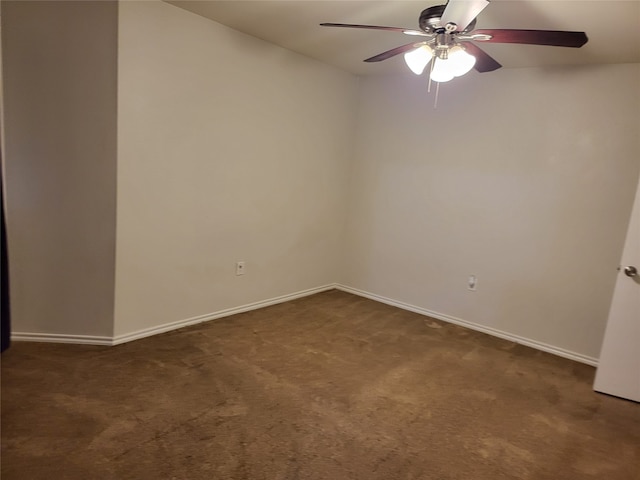 empty room with dark colored carpet and ceiling fan