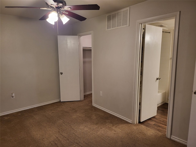 unfurnished bedroom featuring a closet, ceiling fan, and dark colored carpet