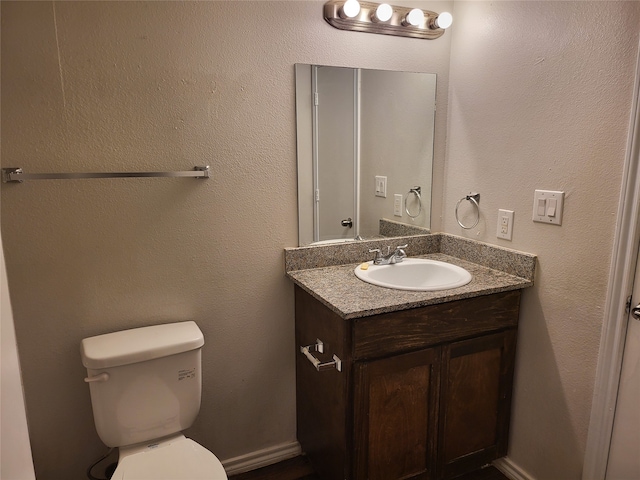 bathroom featuring large vanity and toilet