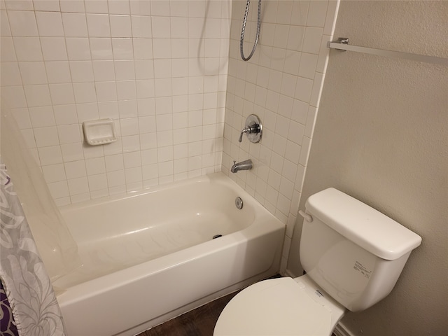 bathroom with shower / tub combo with curtain and toilet