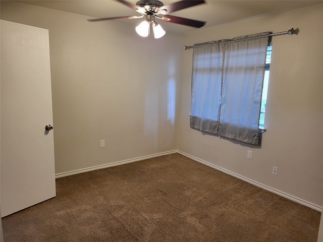 unfurnished room with ceiling fan and dark carpet