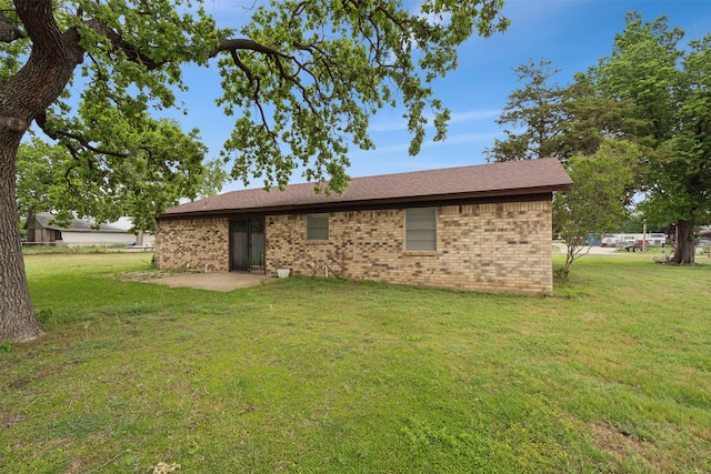 back of property with a patio area and a lawn