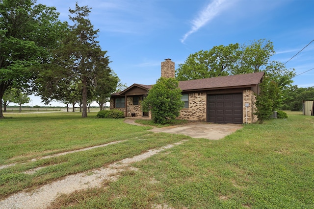 ranch-style house featuring a front lawn and a garage