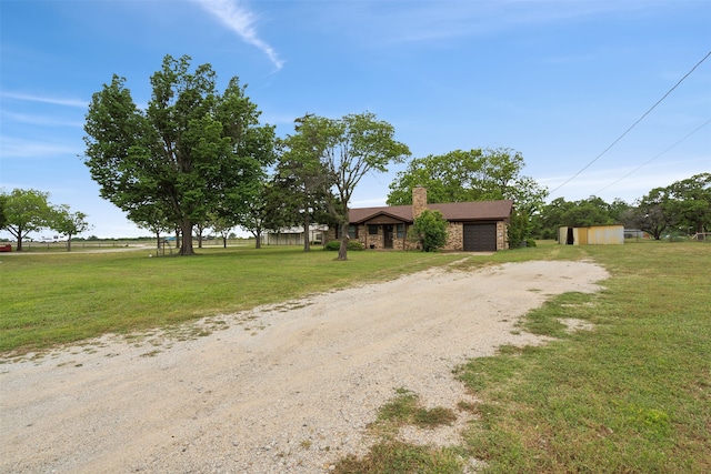 ranch-style home featuring a front yard and a shed