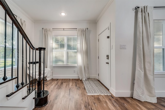 entryway featuring crown molding and hardwood / wood-style floors