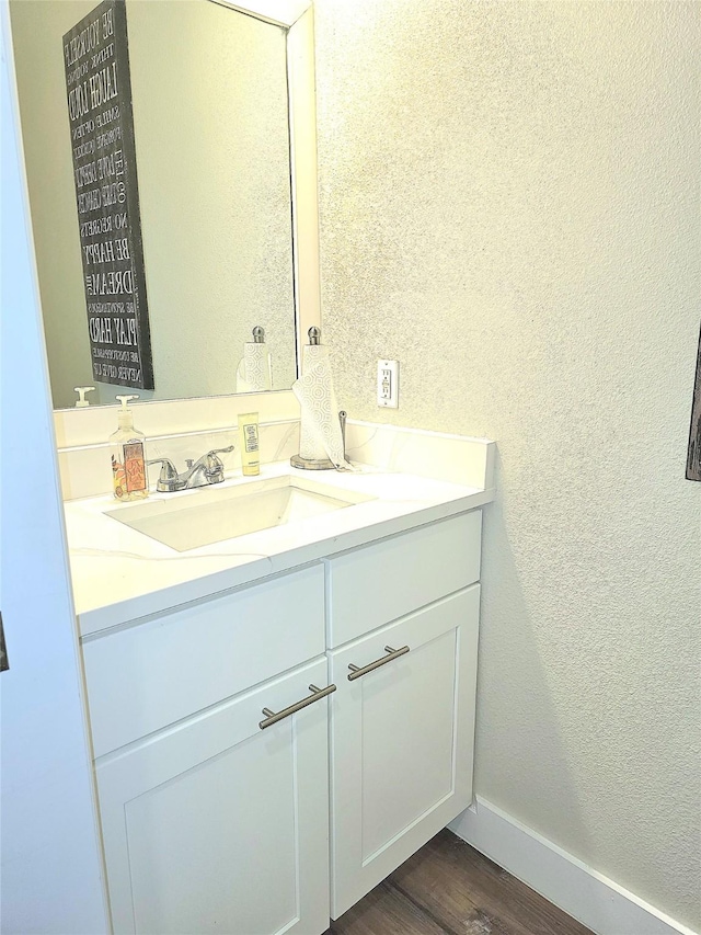 bathroom featuring vanity and wood-type flooring