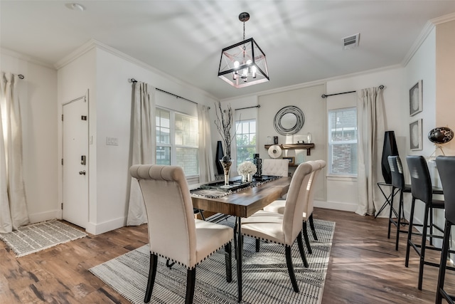 dining area featuring ornamental molding, dark hardwood / wood-style floors, and a notable chandelier