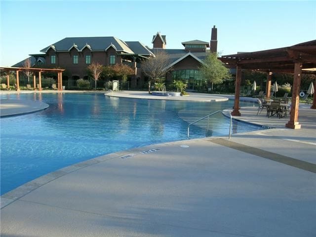 view of pool with a patio and a pergola