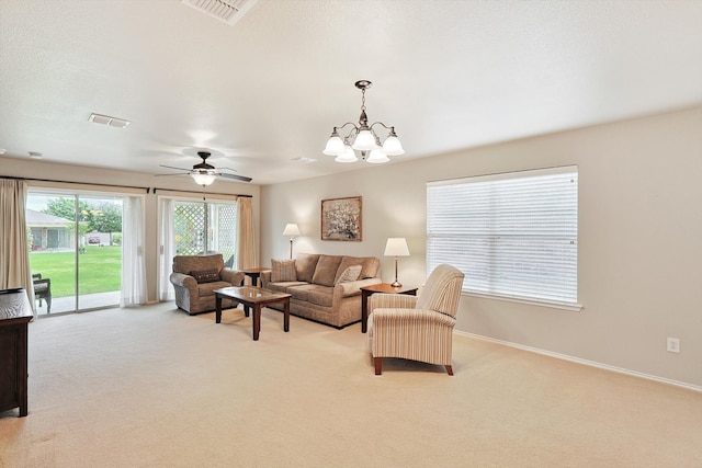 living room with carpet flooring and ceiling fan with notable chandelier