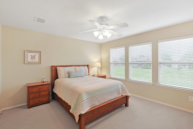 bedroom featuring light carpet and ceiling fan