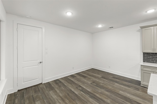 spare room featuring dark hardwood / wood-style floors