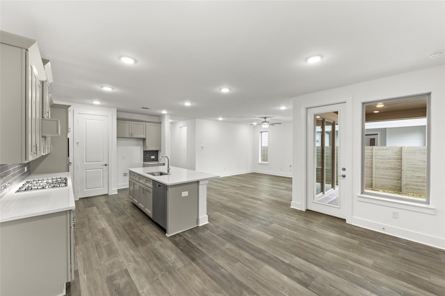 kitchen with gray cabinetry, sink, a kitchen island with sink, and hardwood / wood-style floors