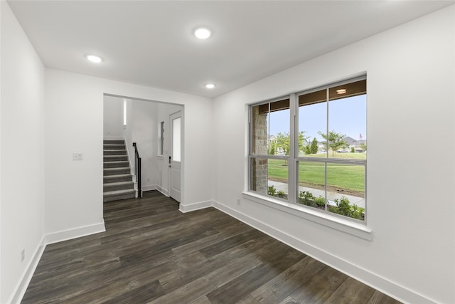 unfurnished room featuring dark wood-type flooring