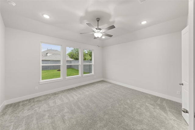 spare room with carpet flooring and ceiling fan