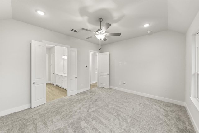 carpeted empty room featuring ceiling fan and vaulted ceiling