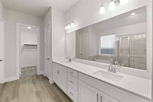 bathroom with hardwood / wood-style flooring, shower with separate bathtub, and dual bowl vanity