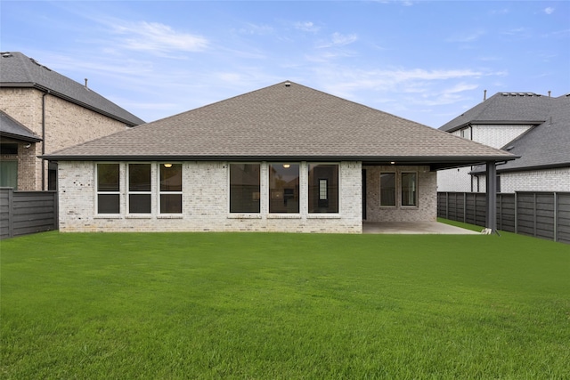 rear view of house with a patio area and a yard